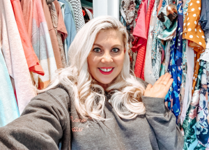 Louise Pentland stands in front of her wardobe of clothes